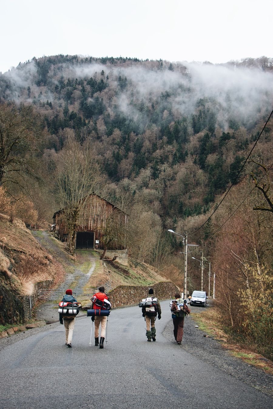 Misty mountain road through lush green hills, a scenic mountain getaway